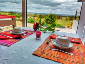 a table with plates and utensils on top of it at Monte Santa Catarina in Monsaraz