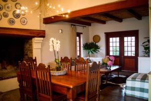 a dining room with a wooden table and chairs at Vineyard Cottage at Bosman Wines in Wellington +53 photos