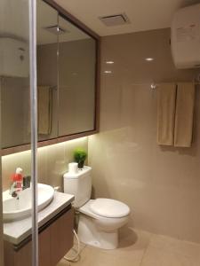 a bathroom with a toilet and a sink at M-Town Signature Gading Serpong by J`s Luxury Apartment in Pumpangsineng