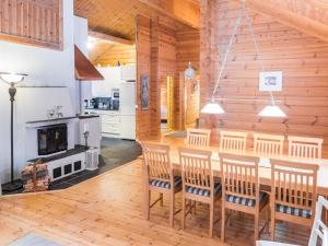 a kitchen and dining room with a table and chairs at Holiday Home Oivangin siesta by Interhome in Nissi