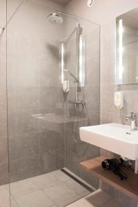 a bathroom with a sink and a shower at Daxburg Apartments in Innsbruck