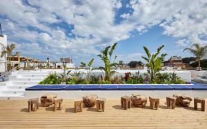 a group of wooden statues sitting on top of a building at Gran Hotel Flamingo-Adults Only older 18 years old in Lloret de Mar