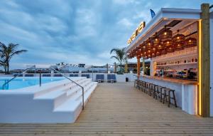 a bar on the rooftop of a resort with a pool at Gran Hotel Flamingo-Adults Only older 18 years old in Lloret de Mar