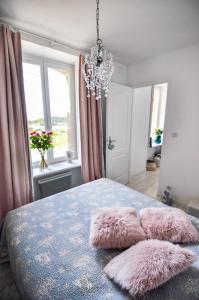 een slaapkamer met een bed met roze kussens erop bij Vue Mer Côte de Granit Rose en Bretagne in Trébeurden