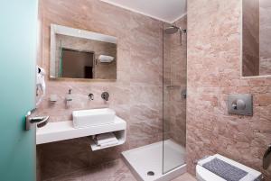 a bathroom with a sink and a shower at Hotel Diamond in Limenaria