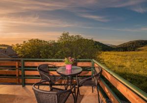 a table and chairs on a balcony with a view at Villa windmill Near Shipwreck Beach in Volimes