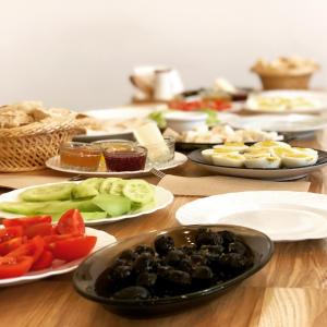 a wooden table with plates of food on it at El Mundo Apartments in Lviv