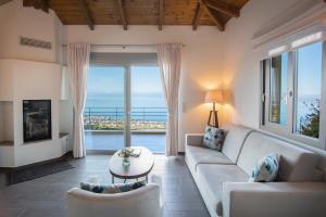 a living room with a couch and a table at Bay View GuestHouses in Kalamata