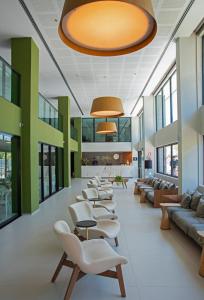 a waiting room with a row of chairs and tables at Porto Kaeté Hotel in Maceió