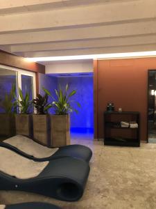 a living room with a couch and some plants at Lamasu RioVerde - Lago di Garda in San Felice del Benaco