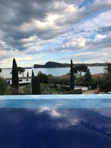 a view of a body of water from a swimming pool at Lamasu RioVerde - Lago di Garda in San Felice del Benaco
