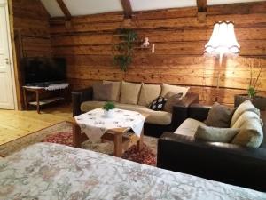 a living room with a couch and a table at Mulgi Apartment in Viljandi