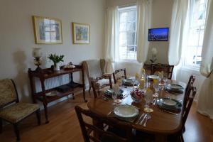 a dining room with a wooden table and chairs at 1 HAVANNAH COURT in Kelso