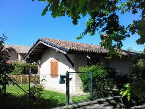 a white house with a fence in front of it at La Casetta in Dronero