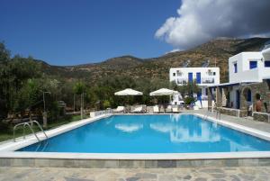 a pool at a resort with mountains in the background at Villa Antoniadis in Platis Yialos Sifnos