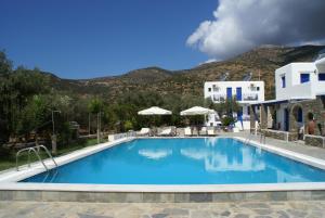 a pool at a resort with mountains in the background at Villa Antoniadis in Platis Gialos