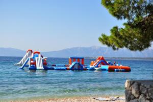 a water park with a bunch of slides in the water at Mobile Homes Aurea Maris - Kamp Dole Živogošće in Živogošće +15 photos