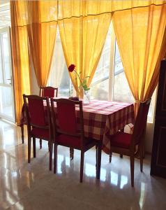 a dining room table and chairs with a vase on it at Hayq Guest House in Goris