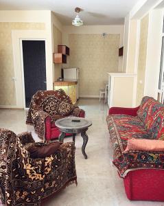 a living room with couches and a table in it at Hayq Guest House in Goris