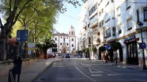 an empty street in a city with a building at Puerta Alameda Suites Mirador Centro Historico in Ronda