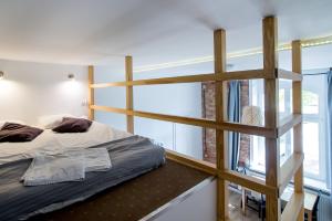 a bedroom with a bunk bed and a ladder at Sopot Spot in Sopot