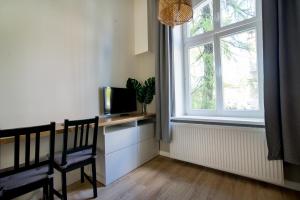 a living room with a tv and a window at Sopot Spot in Sopot