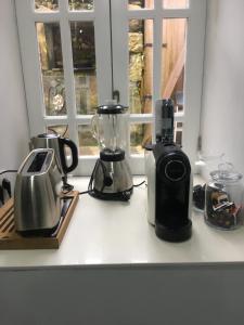 a kitchen counter with appliances on a window sill at ALTAMIRA HOUSE in Viana do Castelo