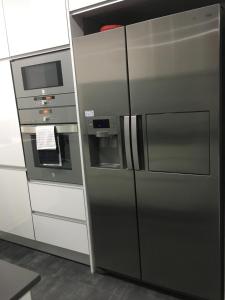 a kitchen with a refrigerator and a microwave at ALTAMIRA HOUSE in Viana do Castelo