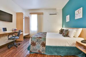 Ένα ή περισσότερα κρεβάτια σε δωμάτιο στο Comfort Hotel Joinville