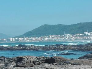 a view of the ocean with a city in the background at Casas do Pedro T3 in Vila Praia de Âncora
