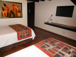 Letto o letti in una camera di Hotel Hacienda Taboada (Aguas Termales)
