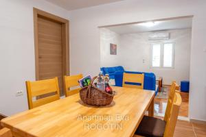 comedor con mesa de madera y sillas en Apartman Eva Rogotin, en Rogotin