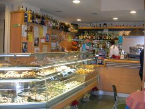 a bakery with a display case in a store at Caffè Nuovo 2 Holiday Rooms in Trappitello