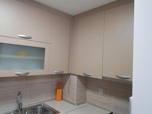 a kitchen with a sink and a mirror at Apartman KRISTINA,Istocno Sarajevo,Vojvode Radomira Putnika 49D in Sarajevo +37 photos