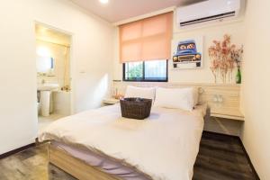 Voodi või voodid majutusasutuse Meizhou Hot Spring Hotel溫泉商旅 toas