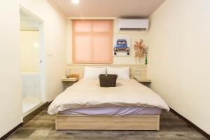 Voodi või voodid majutusasutuse Meizhou Hot Spring Hotel溫泉商旅 toas