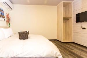 Voodi või voodid majutusasutuse Meizhou Hot Spring Hotel溫泉商旅 toas