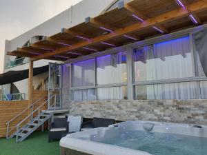 a large room with a hot tub and a staircase at Avshalom Holiday Apartments in Eilat