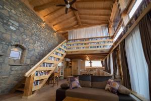 a living room with a couch and a stone wall at Guest House Epochs since 1871 in Lyaskovets