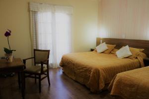 מיטה או מיטות בחדר ב-Hotel Bologna