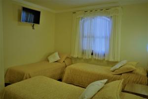 Hotel Bologna tesisinde bir odada yatak veya yataklar