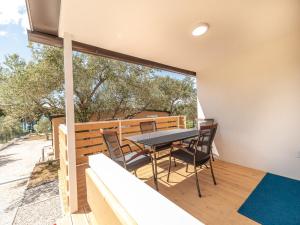 a dining room with a table and chairs on a balcony at Mobile House Fantina in Sveti Filip i Jakov