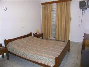 A bed or beds in a room at Cypriana Apartments