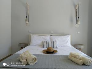 - un lit avec des serviettes et un chapeau dans l'établissement Studios Paleokastritsa - Sun's Gift, à Paleokastritsa