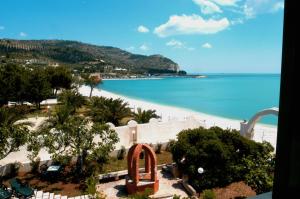 a view of the beach from the balcony of a resort at B & B Torre Saracena in Mattinata