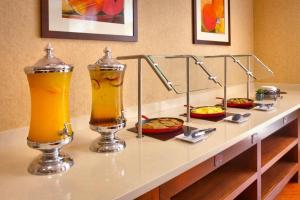 a buffet with two drinks and pizzas on a table at Cortona Inn and Suites Anaheim Resort in Anaheim