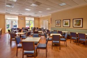 a dining room with tables and chairs in a building at Cortona Inn and Suites Anaheim Resort in Anaheim