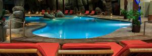 a large swimming pool with red chairs around it at Bally's Lake Tahoe Casino Resort in Stateline
