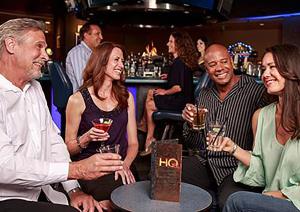 a group of people sitting in a bar with drinks at Bally's Lake Tahoe Casino Resort in Stateline