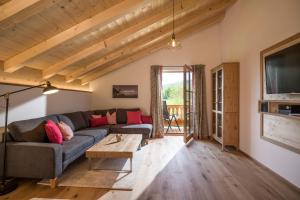 a living room with a couch and a table at Lainthalerhof in Oberaudorf